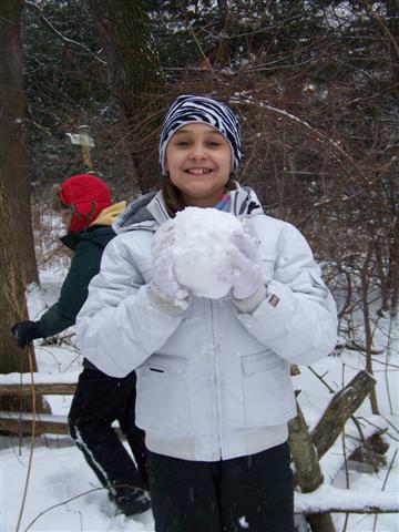 Girl in snow with snowball